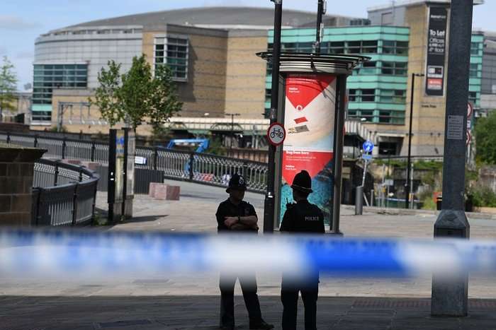 Police stand guard near the Manchester Arena.