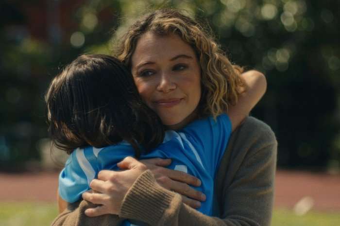 Maximum_Pleasure_Guaranteed_Photo_010208 Tatiana Maslany's character in Maximum Pleasure Guaranteed, hugging a child.