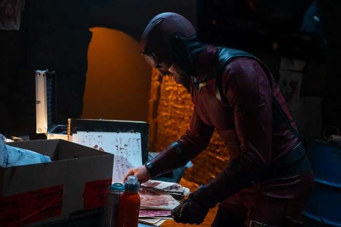Daredevil/Matt Murdock (Charlie Cox) in Daredevil: Born Again looking at a messy desk