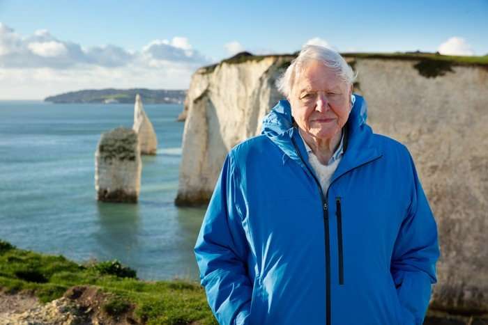 David Attenborough stood in front of cliffs and the sea for Ocean With David Attenborough