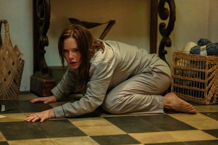 Holliday Grainger as Rebecca Walsh/Nina Thibault in The Stolen Girl, crouched on the floor