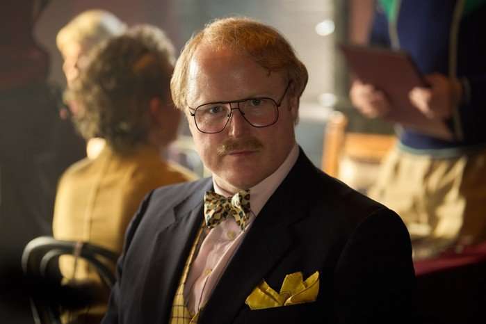 Gary Lamont as Charles Fairburn in Rivals in a navy suit