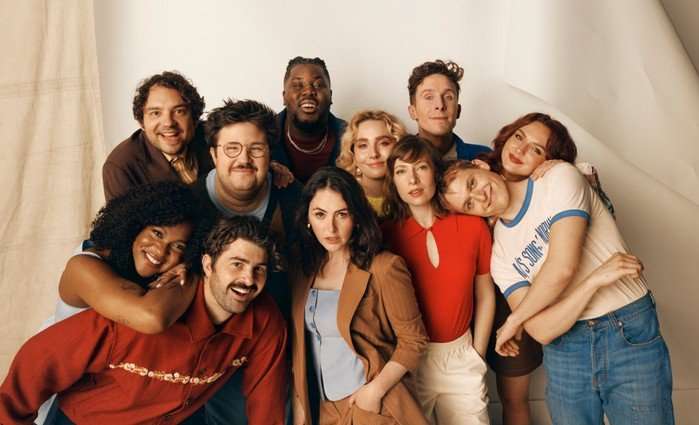 Celeste Dring, Hammed Animashaun, Larry Dean, George Fouracres, Jack Shep, Ayoade Bamgboye, Al Nash, Paddy Young, Ania Magliano, Annabel Marlow and Emma Sidi all stood in a huddle next to one another, posing and smiling ahead.