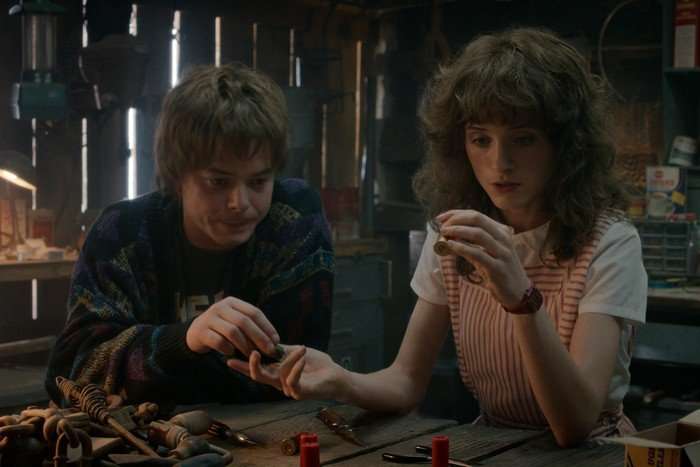 Charlie Heaton as Jonathan Byers and Natalia Dyer as Nancy Wheeler in Stranger Things season 5 Charlie Heaton as Jonathan Byers and Natalia Dyer as Nancy Wheeler in Stranger Things season 5, putting together a piece of tech