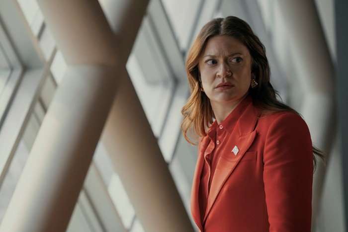 Colby Minifie as Ashley Barrett in The Boys, wearing a red suit.