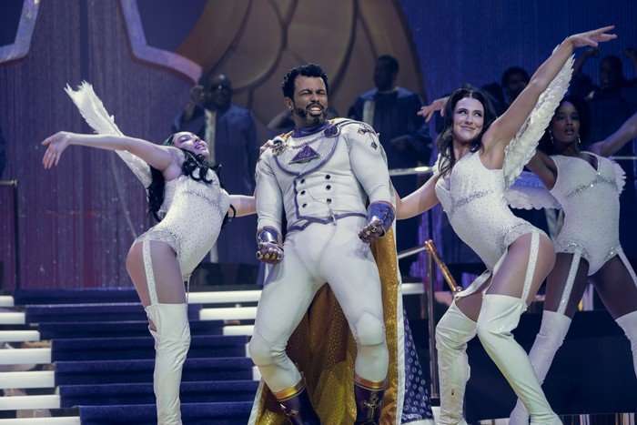 Daveed Diggs as Oh Father in The Boys, dancing on a stage with two female dancers either side of him.