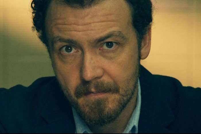 Under Suspicion: Kate McCann (wt) Miguel Freire as Ricardo Paiva in Under Suspicion: Kate McCann looking seriously ahead, wearing a shirt and blazer.