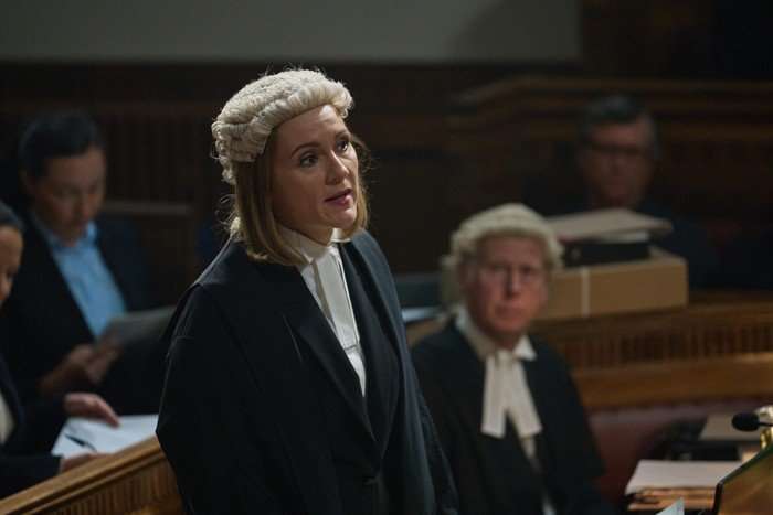 Rachael Stirling as Phillippa Kaufmann in Believe Me standing up in court, wearing her court wig and gown, standing up to talk to someone.