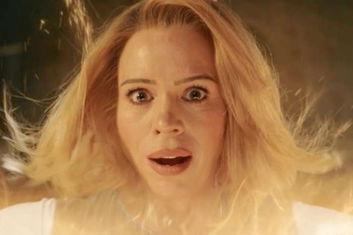 billie-piper-regeneration Billie Piper stares wide-eyed in shock as golden energy flares around her face, hair lifting in a glowing burst of light, in a scene from Doctor Who.