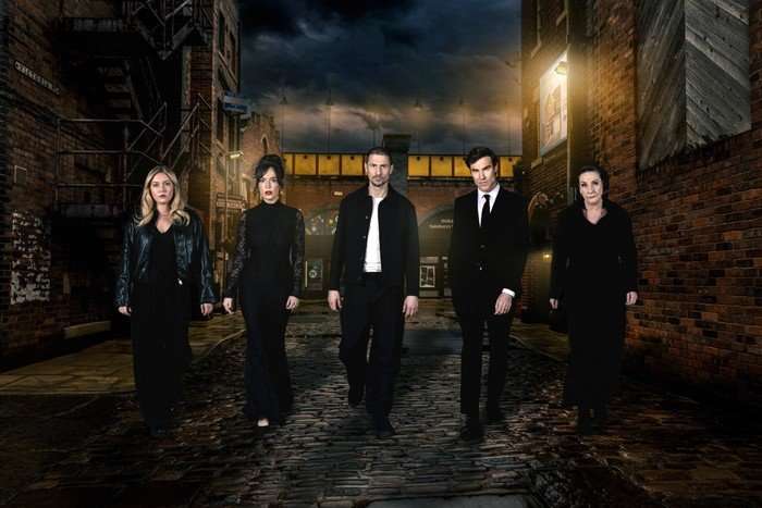 Megan, Jodie, Carl, Theo and Maggie - dressed in funeral attire - walk down Victoria Street in key art for Coronation Street's murder week