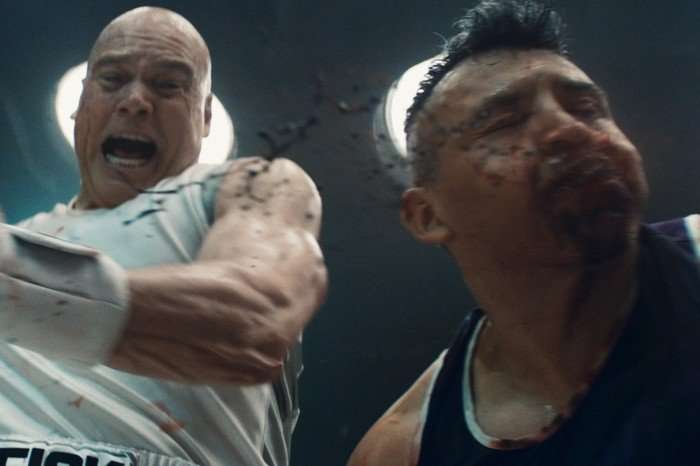 Wilson Fisk punches his bloodied, unconscious opponent in a boxing match in a scene from Daredevil: Born Again season 2