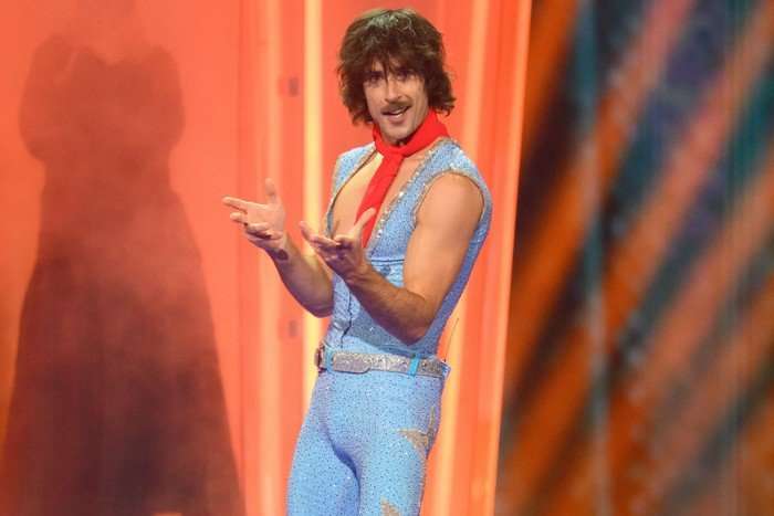 Go-Jo wearing a light blue denim two-piece with a red neckerchief.