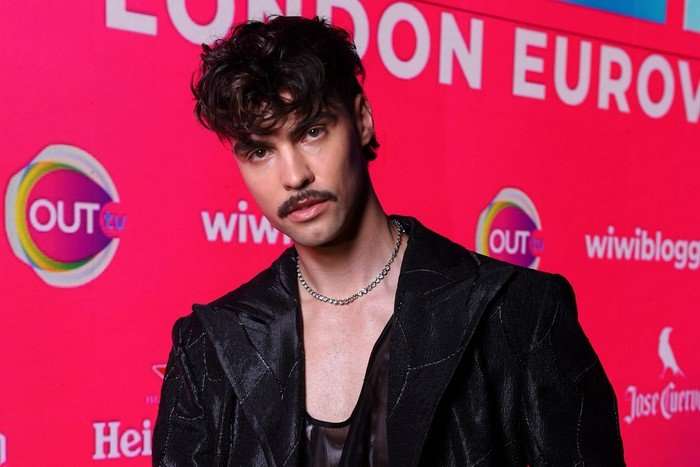 A person wearing an all black outfit, looking directly ahead.