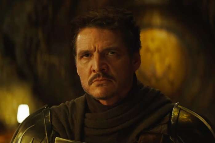 Pedro Pascal stars in The Mandalorian & Grogu; in this scene, Din Djarin is looking up at someone with anger and disgust