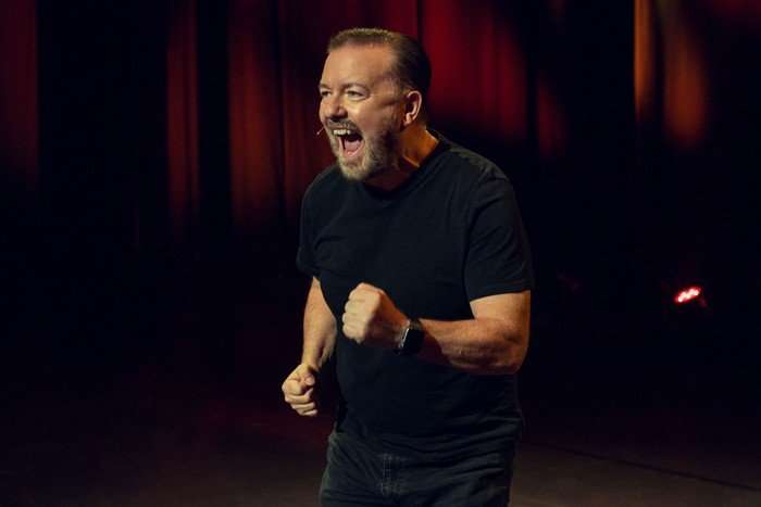 ricky-gervais Ricky Gervais wearing a black t-shirt with his mouth open
