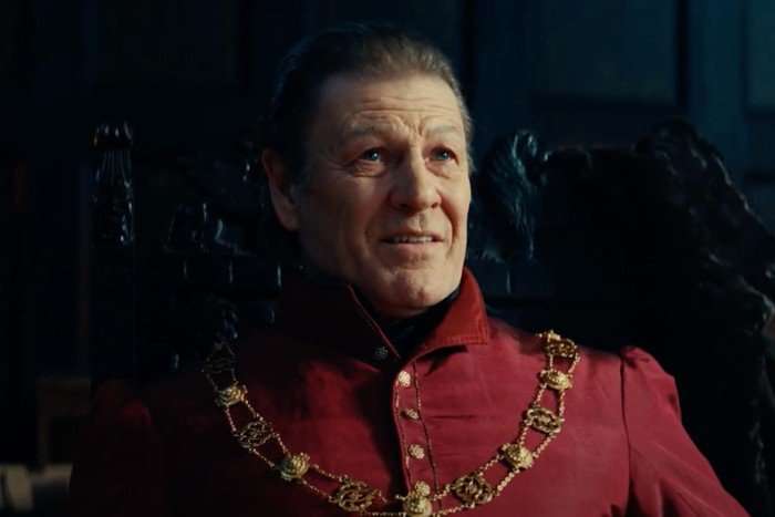 Sean Bean as Thomas Cromwell in Shardlake. He is wearing a red outfit with gems across his chest