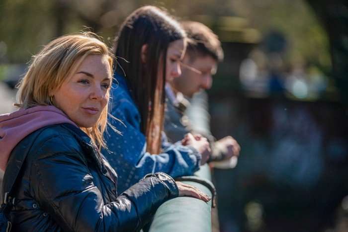 Sheridan Smith, Freya Jones and Michael Socha standing on a bridge, looking out together.