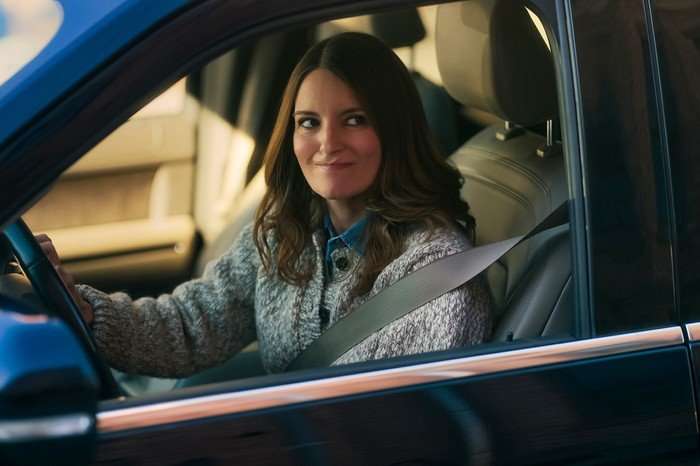 tina-fey-four-seasons Tina Fey plays Kate in The Four Seasons, sitting in a car and awkwardly smirking out of the passenger window