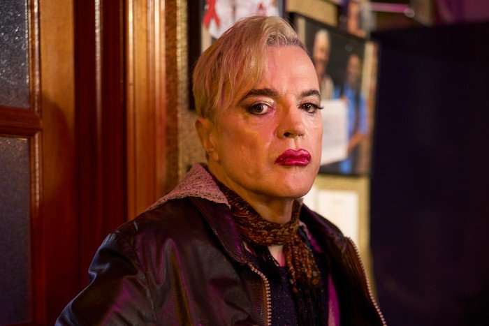 Paul Rhys as Melba in Tip Toe. They are sat at a bar looking unhappy.