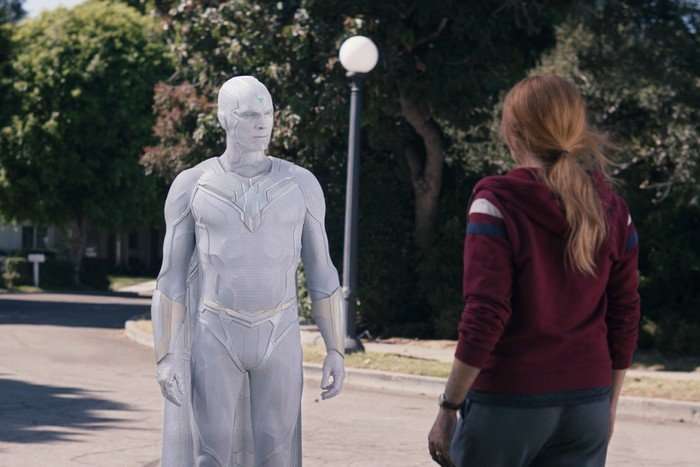 white-vision-wandavision White Vision stands before a startled Wanda Maximoff on a suburban street, in a scene from WandaVision