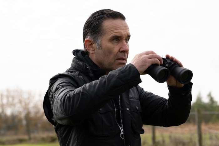 Graham Foster using binoculars in a scene from Emmerdale