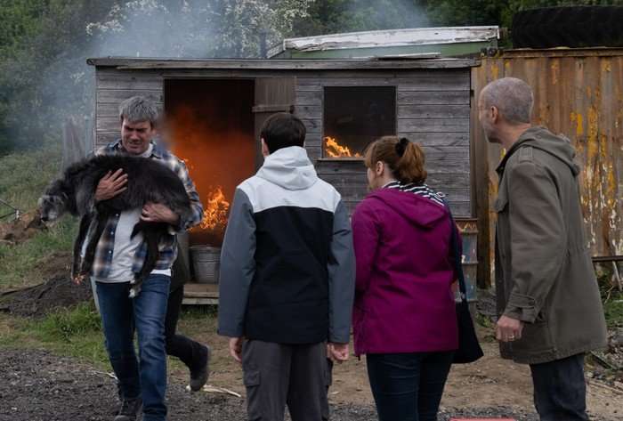 The Dingles watch in horror as Cain rescues Monty the dog from a burning shed in Emmerdale