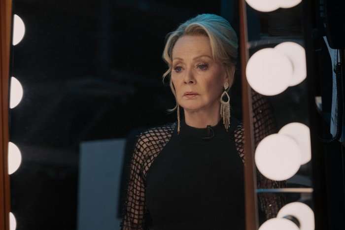 Jean Smart as Deborah Vance in Hacks, sitting in front of a dressing room mirror and looking troubled