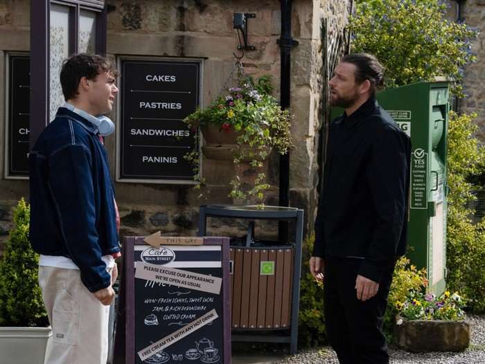 Kev talks to Lewis outside of the caff in Emmerdale