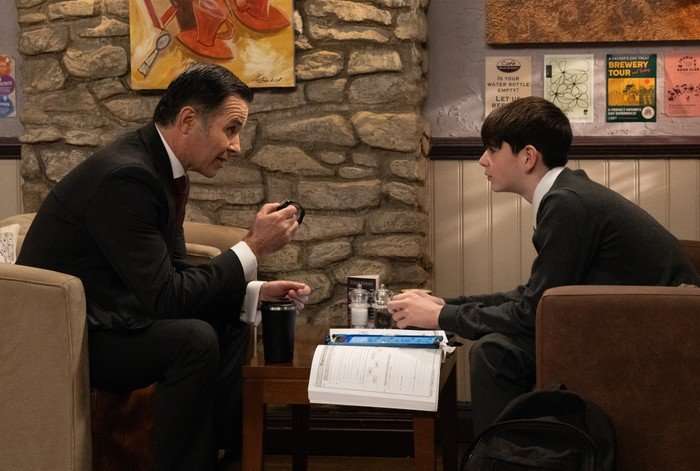Graham and Kyle have a conversation across a coffee table in the cafe in Emmerdale