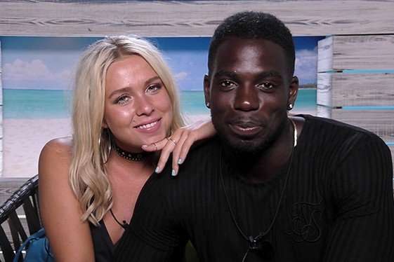 Gabby Allen and Marcel Somerville Gabby Allen and Marcel Somerville. Gabby is resting on Marcel's shoulder as they both smile ahead in the beach hut.