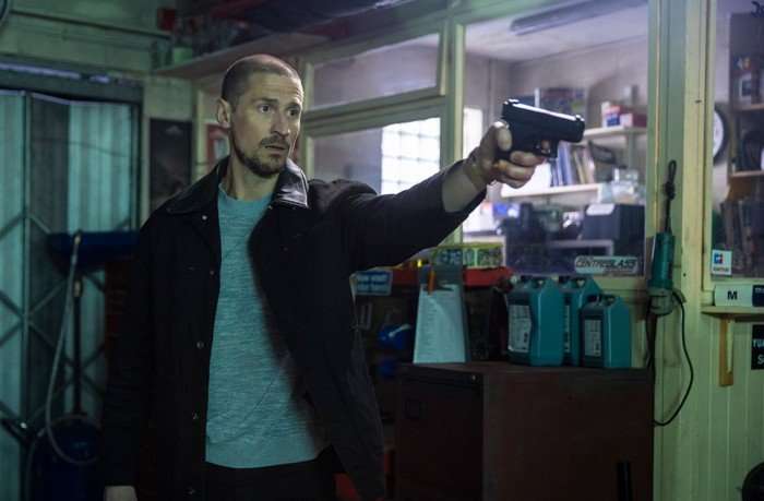15_06_coro_garage_05 Carl aims a shotgun in a scene from Coronation Street