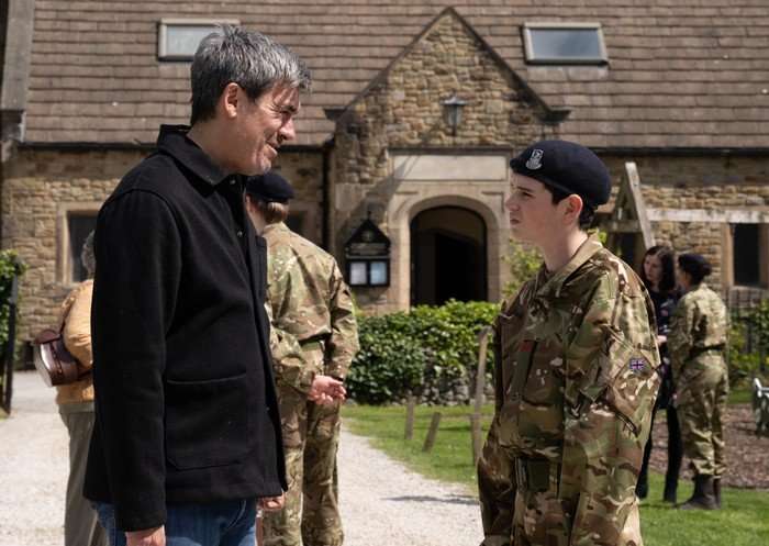 15_06_emm_cain_kyle Cain chats to Kyle, who is wearing his cadets uniform, in a scene from Emmerdale