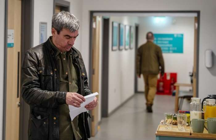 24_03_emm_cain_02 Cain opens a letter in a hospital corridor in Emmerdale