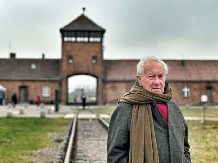 515966,Simon Schama: The Road to Auschwitz Simon Schama stood in front of Auschwitz.