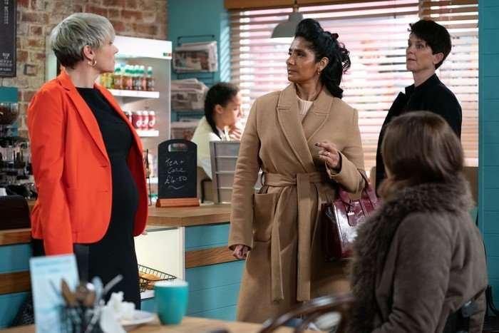553804,TITLE:Eastenders Laura Doddington as Nicola Mitchell looking at Balvinder Sopal as Suki Panesar-Unwin and Heather Peace as Eve Panesar-Unwin in EastEnders in the cafe.