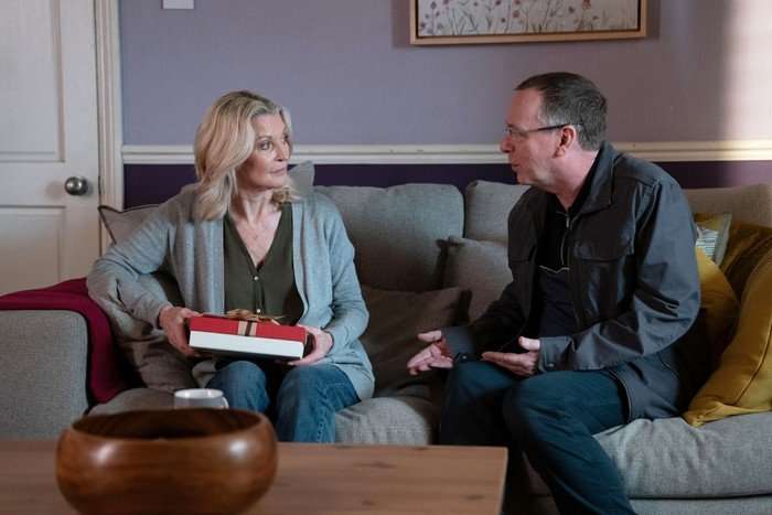 564809,TITLE:Eastenders Kathy and Ian sat on their sofa in a scene from EastEnders