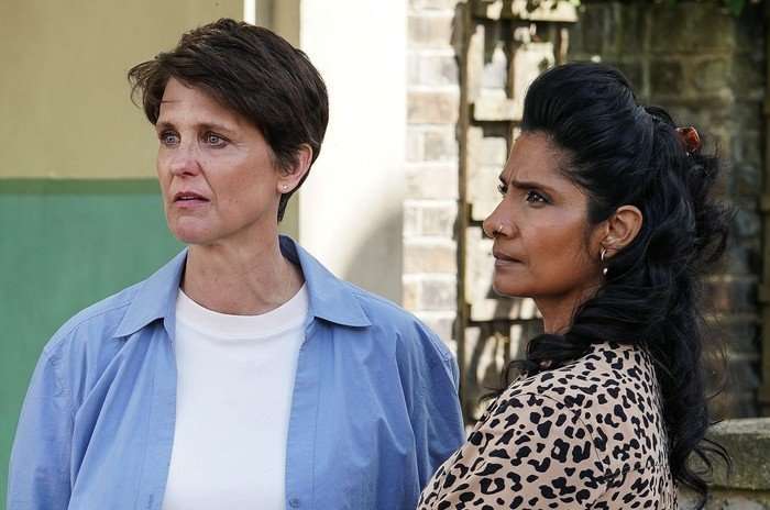Eve and Suki look shocked in a scene from EastEnders