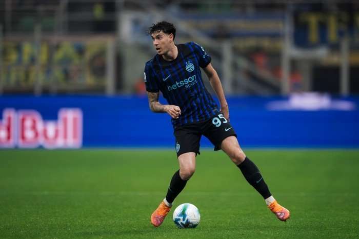 Alessandro Bastoni Alessandro Bastoni, in blue and black Inter kit, looks ahead as he controls the football.