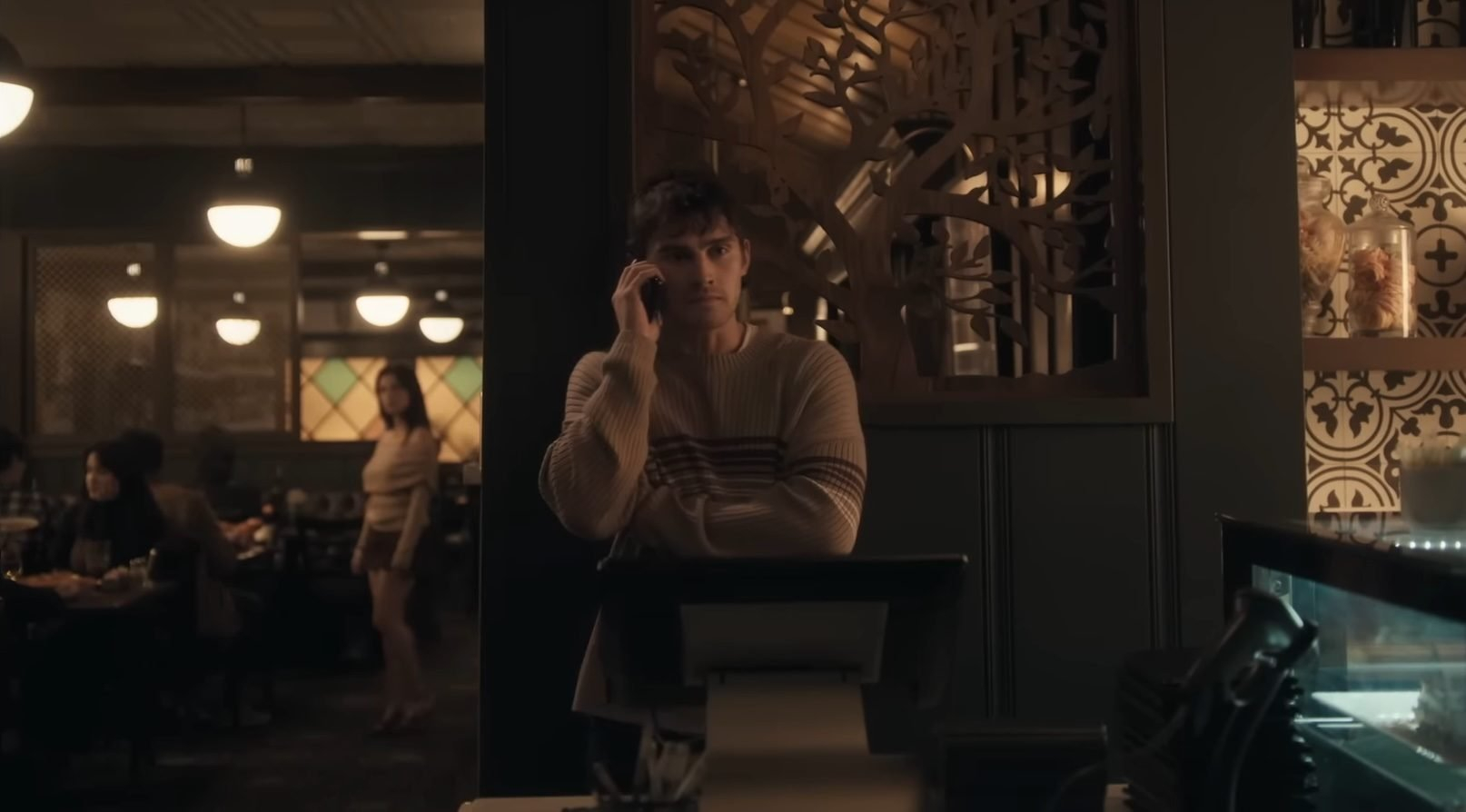 Bear (Michael Johnston) using the phone while Nikki (Inde Navarrette) watches in the horror film, Obsession.