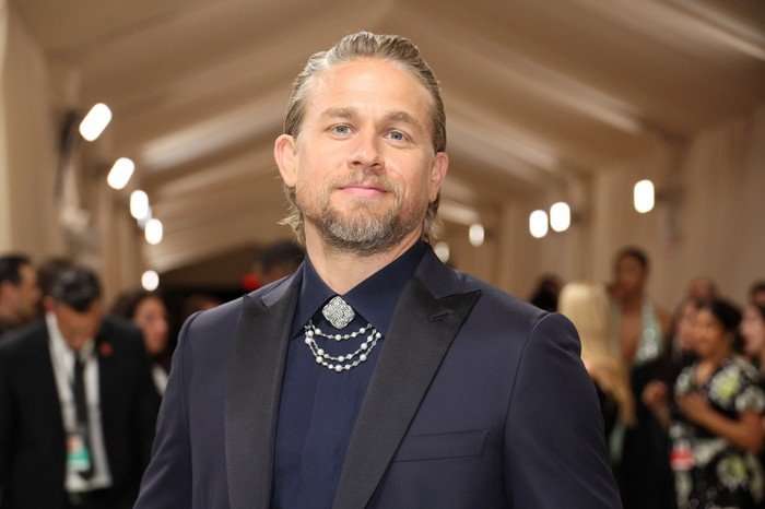 The 2024 Met Gala Celebrating "Sleeping Beauties: Reawakening Fashion" - Arrivals Charlie Hunnam standing on the red carpet of the Met Gala, wearing a black shirt and suit.