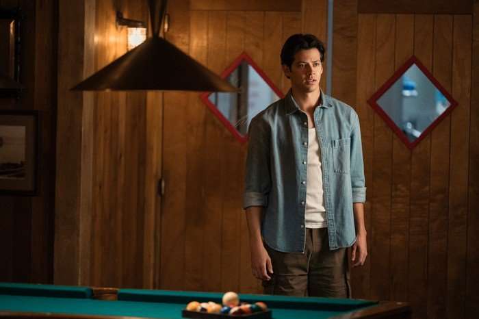 Every Year After Matt Cornett as Sam Florek standing by a pool table, wearing a denim shirt and khaki trousers, with his arms by his side.