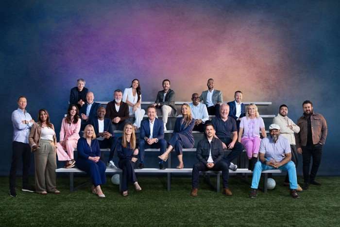 ITV World Cup 2026 The ITV broadcast team for the World Cup sit on bleachers in front of a multicoloured background at a photoshoot.