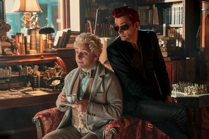 Michael Sheen David Tennant Good Omens Michael Sheen and David Tennant in Good Omens season 2 sitting together.