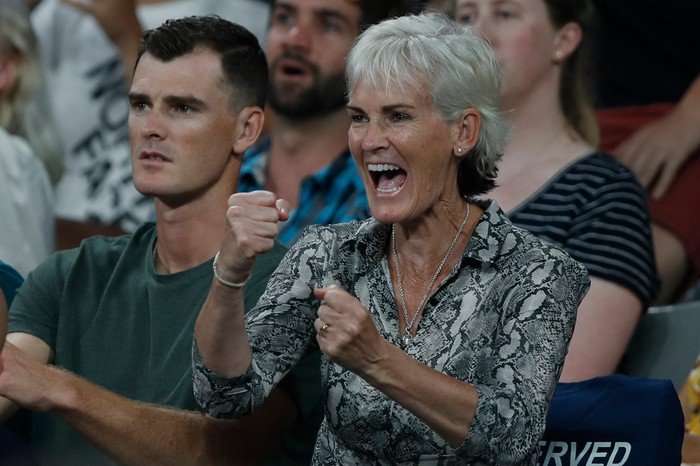 Tennis player Jamie Murray and his mum Judy Murray watching a game of tennis - she's very excited, with her fists clenched.