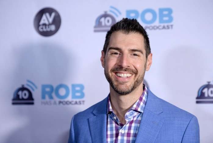 the-traitors-US Rob Cesternino smiles ahead wearing a powder blue suit.