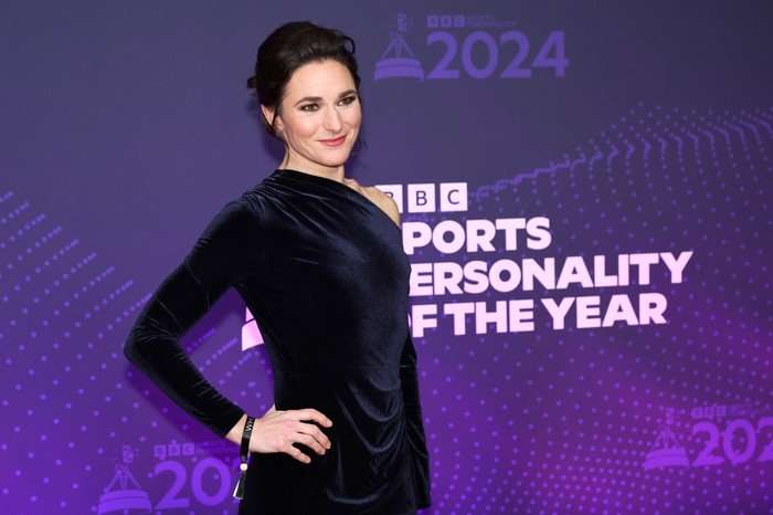 BBC Sports Personality Of The Year 2024 - Arrivals Sarah Storey stood smiling with one hand on her hip as she poses for a photo on a red carpet.