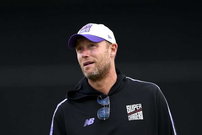 Northern Superchargers Men v Welsh Fire Men - The Hundred Freddie Flintoff wearing a cap, wearing a black hoodie as he smiles slightly ahead.