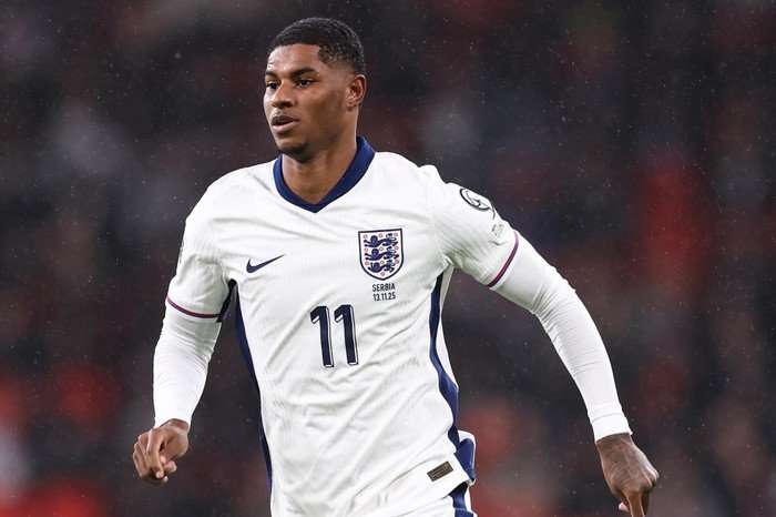 England v Uruguay England forward Marcus Rashford, in white and blue football kit, runs on the pitch at Wembley.
