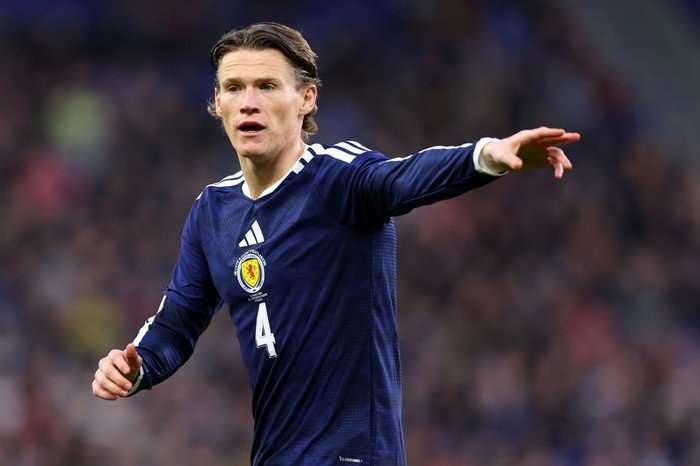 Scott McTominay Scotland midfielder Scott McTominay, in blue football kit, points on the pitch.