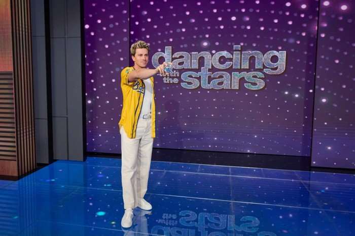 JACKSON OLSON Jackson Olson stood on a stage in front of a Dancing with the Stars background, holding a sparkly baseball.